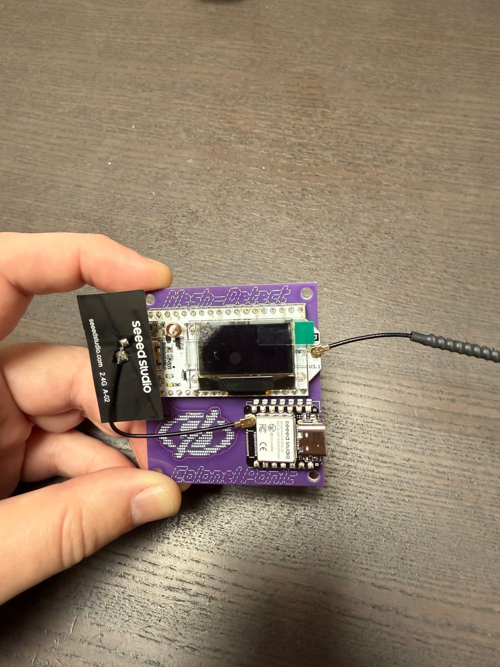 Front side of the mesh detect board, showing the Heltec V3, and the Seeed studio ESP32 (and nice branding by ColonelPanic)