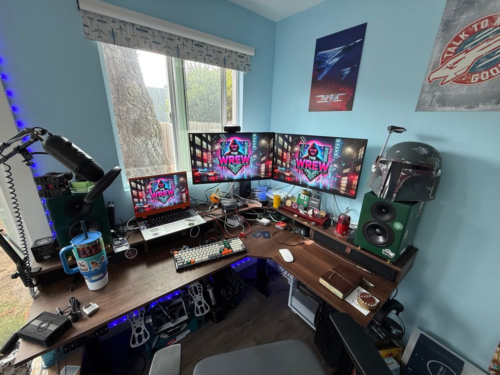 The Wrew’s office with desk, multiple monitors, speakers, and too many cables…
