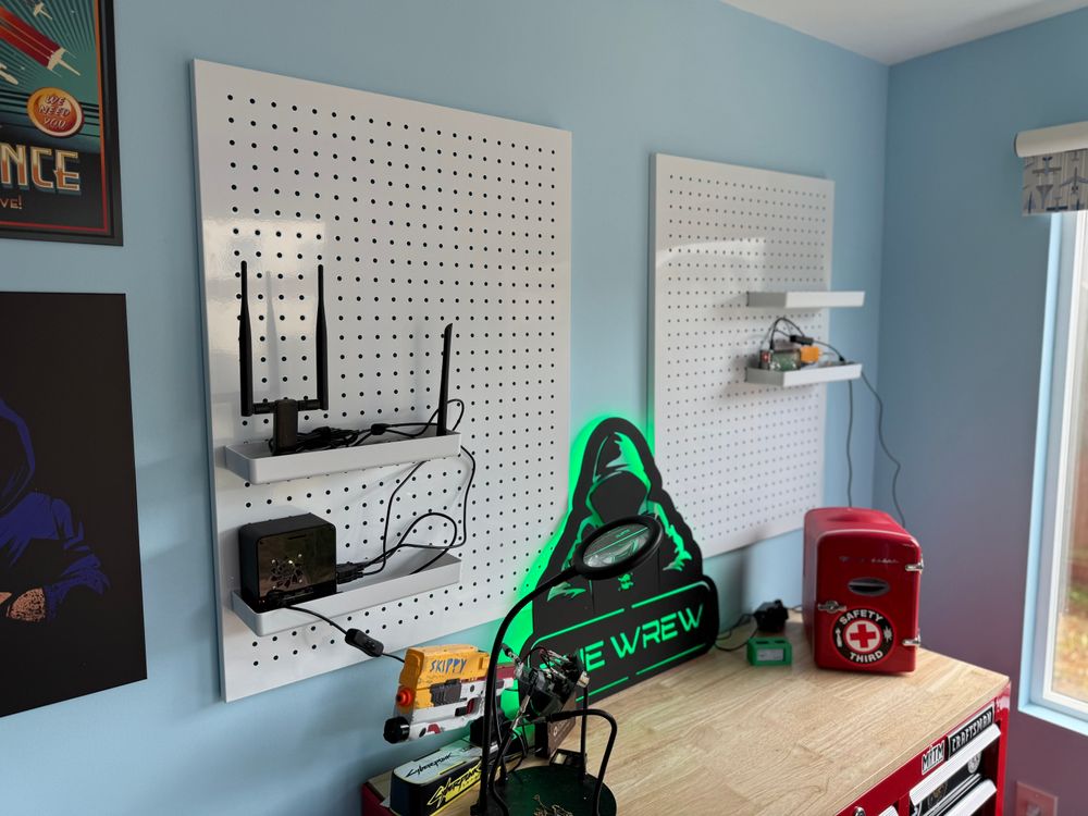 My office showing my workbench, The Wrew light up sign, and newly installed pegboard 