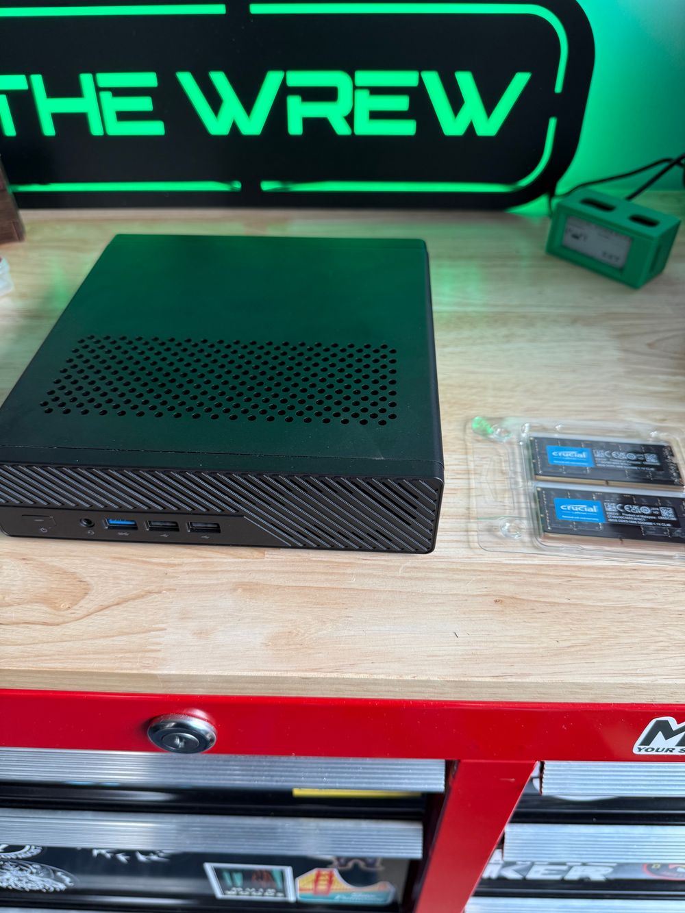 A mini form factor workstation sitting next to two sticks of RAM